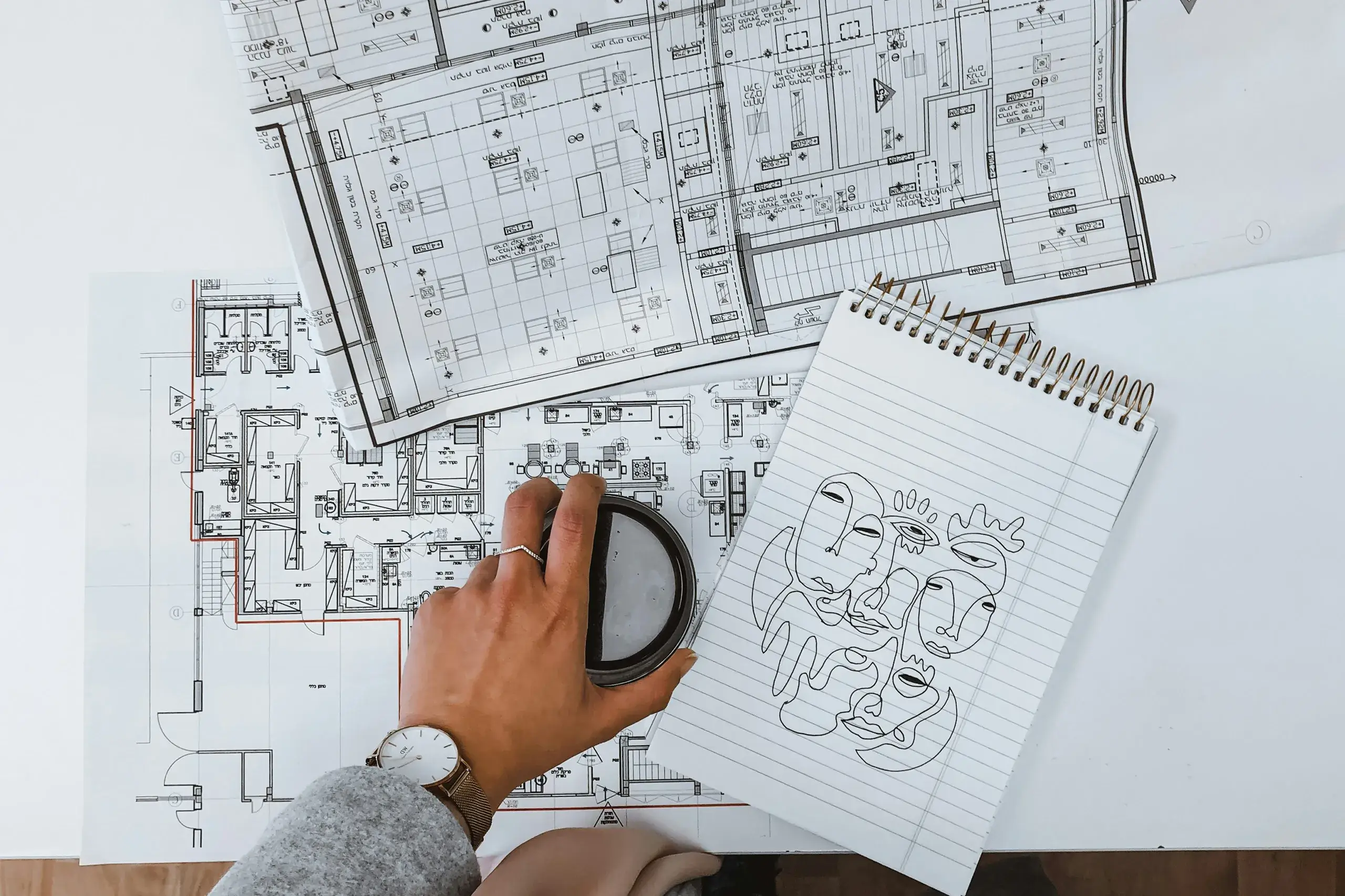 Person sketching blueprints